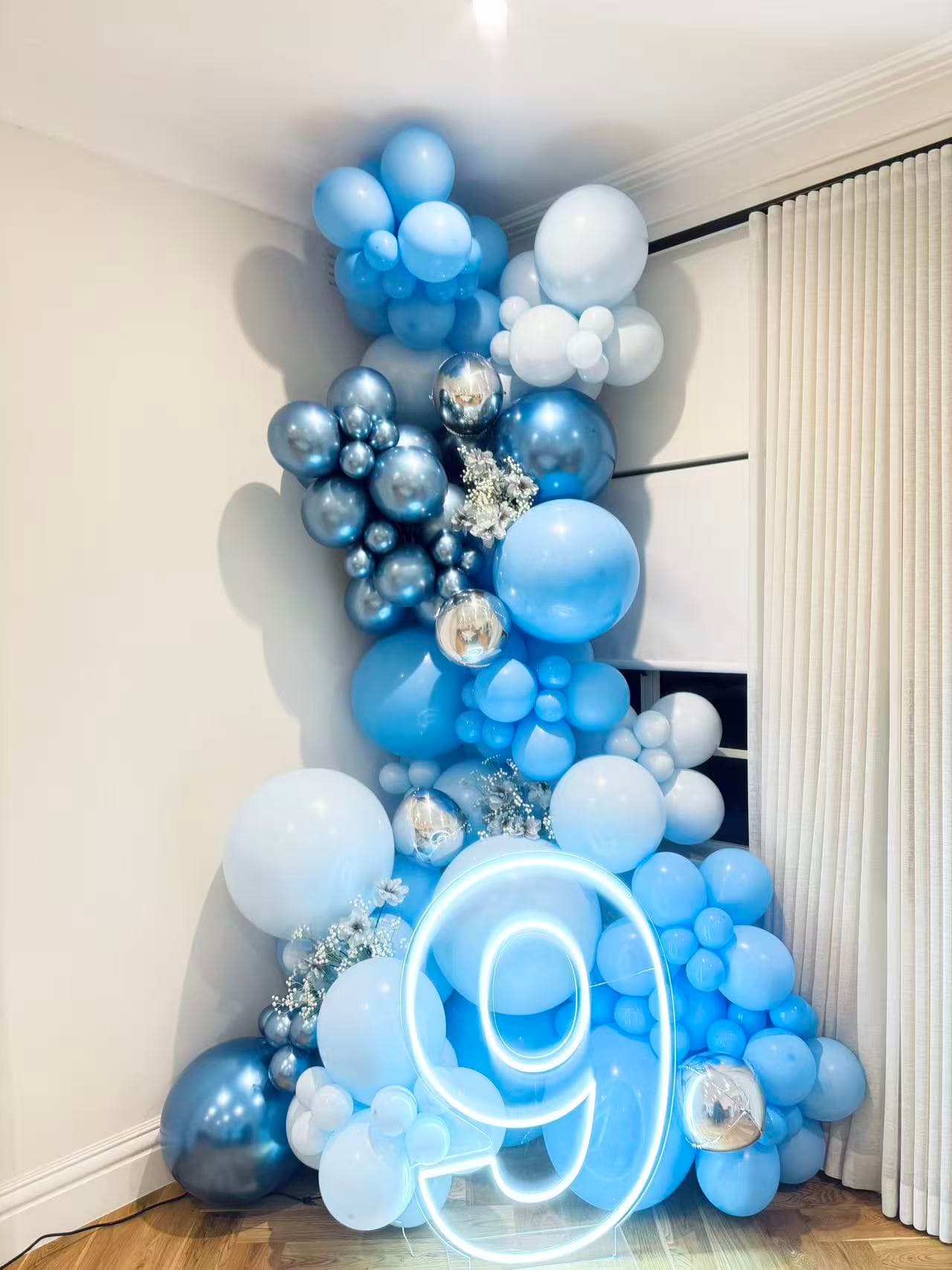 Blue and silver organic balloon garland with neon number 9.