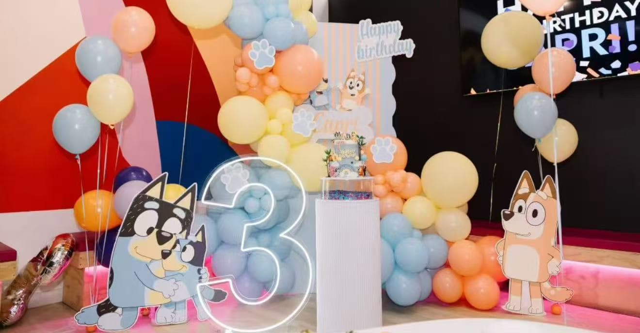 Bluey themed 3rd birthday with pastel balloons and neon number.