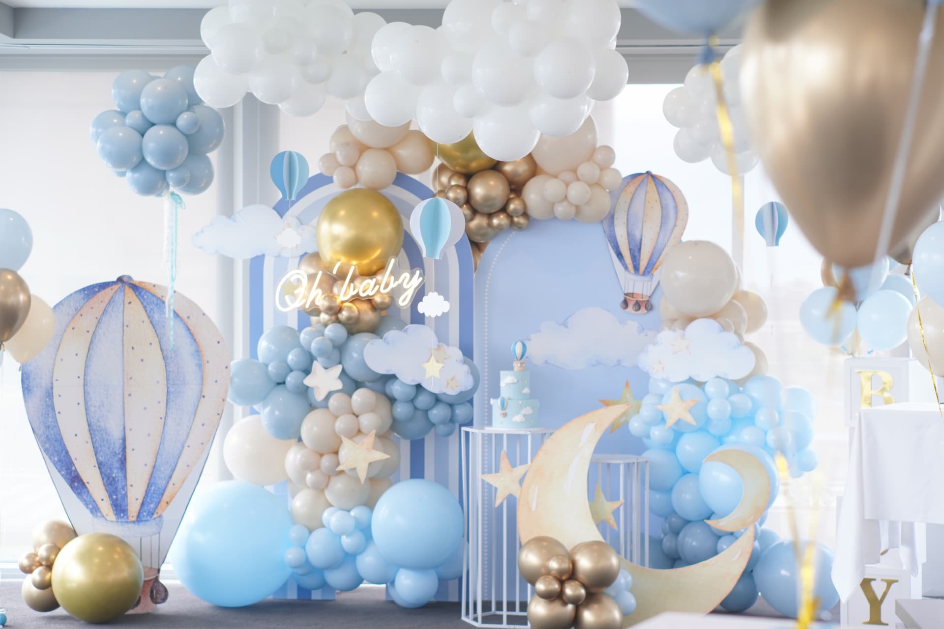 Hot air balloon and sky themed 1st birthday with light blue, white, gold and beige balloon garland
