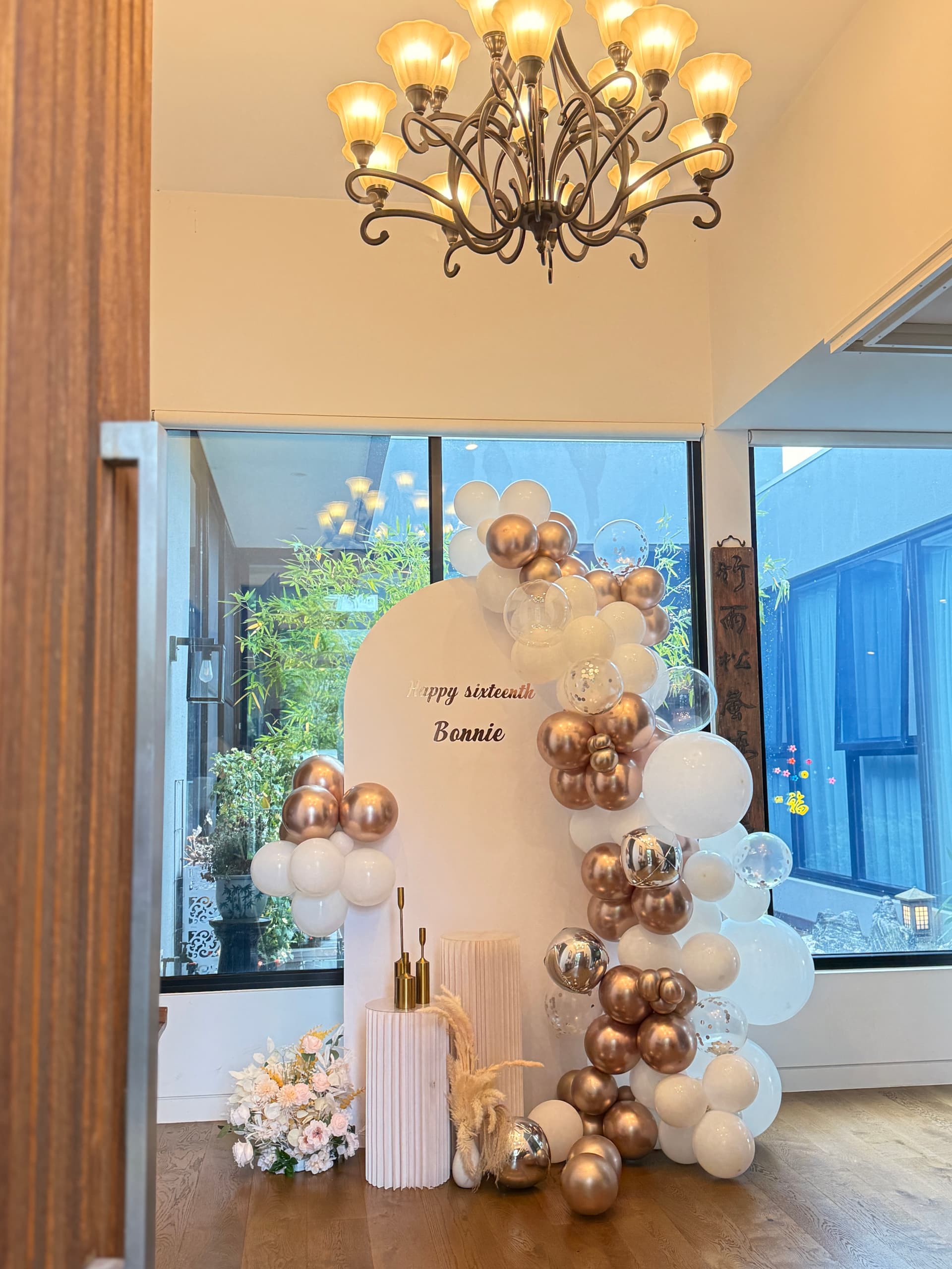 Rose gold and white themed 1st birthday for Romana with elegant balloon arch and acrylic sign
