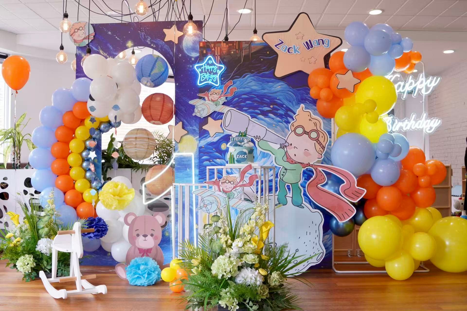 Space adventure 1st birthday for Zack with planets, rainbow balloons and neon.