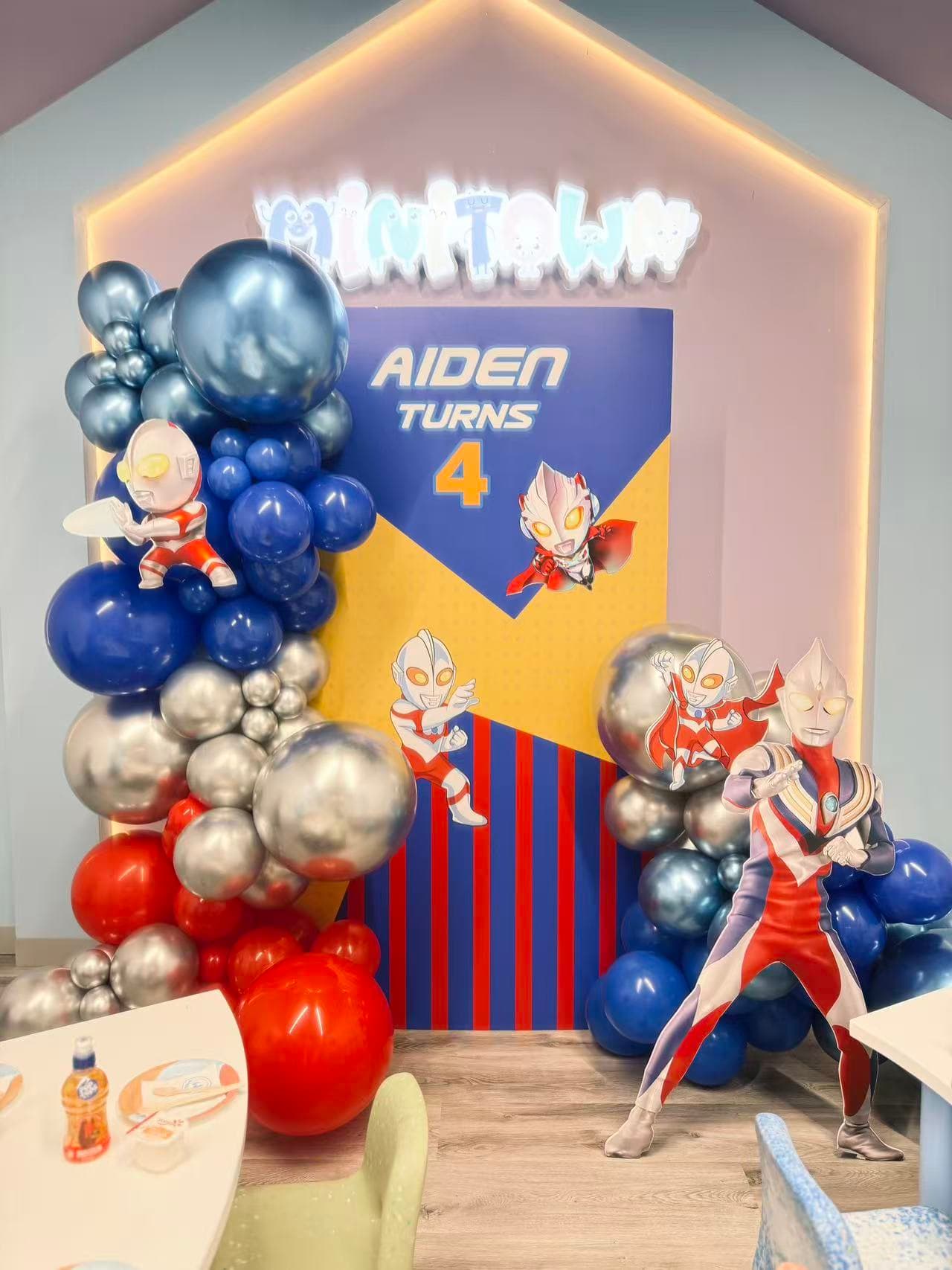 Ultraman themed 4th birthday for Aiden in red, blue and silver tones.