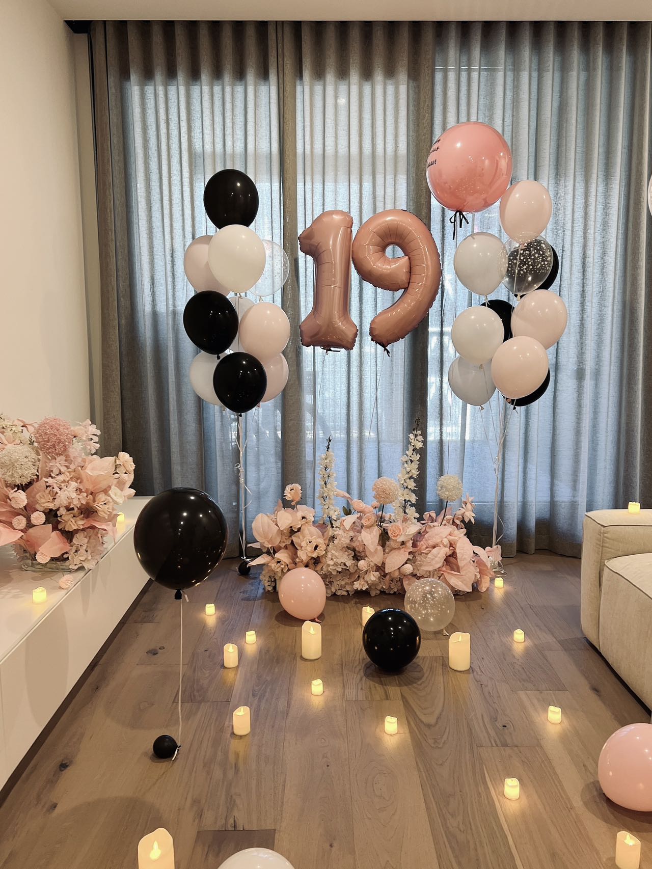 Romantic 19th birthday setup with pink and black balloons