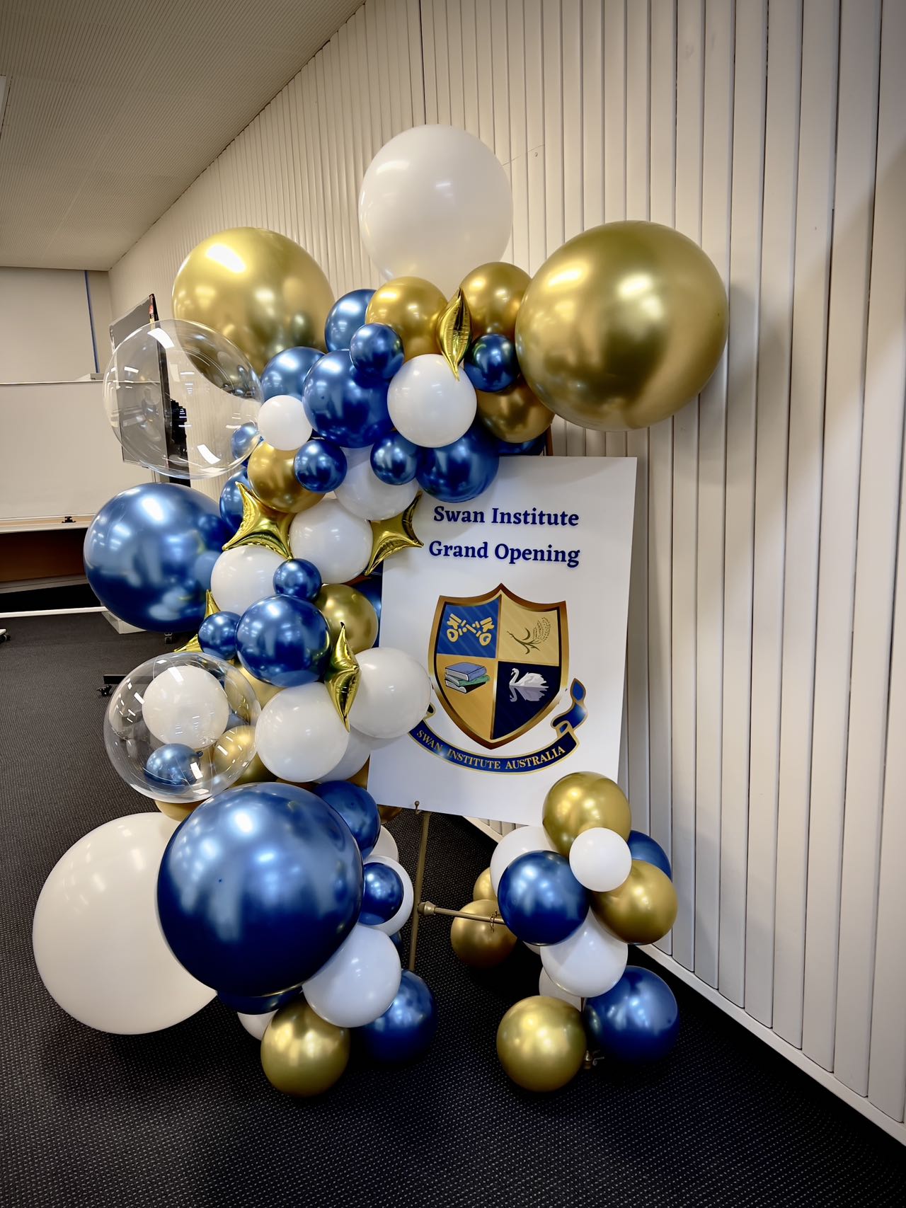 Educational institute grand opening with royal blue and gold balloon decorations