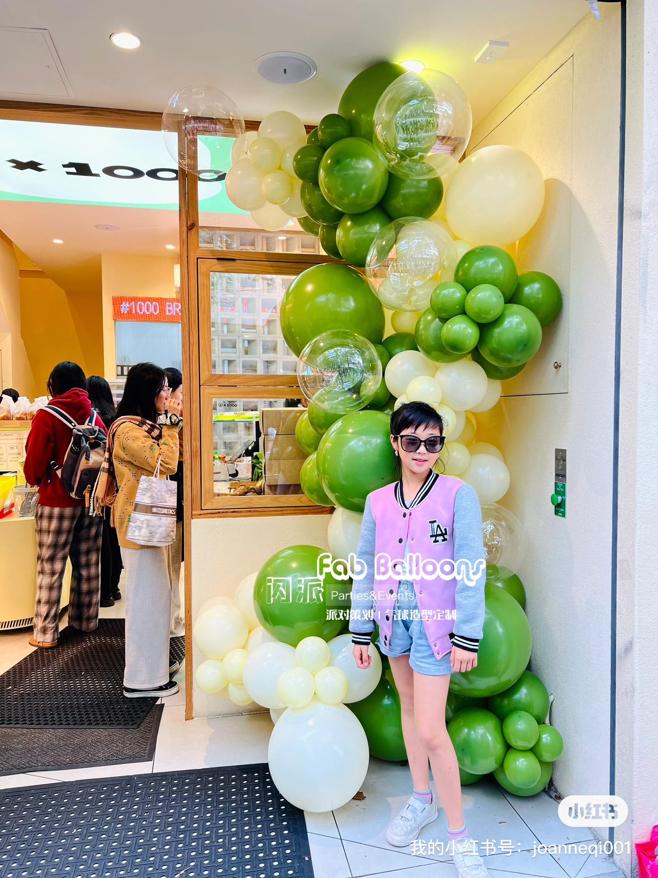 Juice bar entrance decorated with fresh lime green and white balloon garland