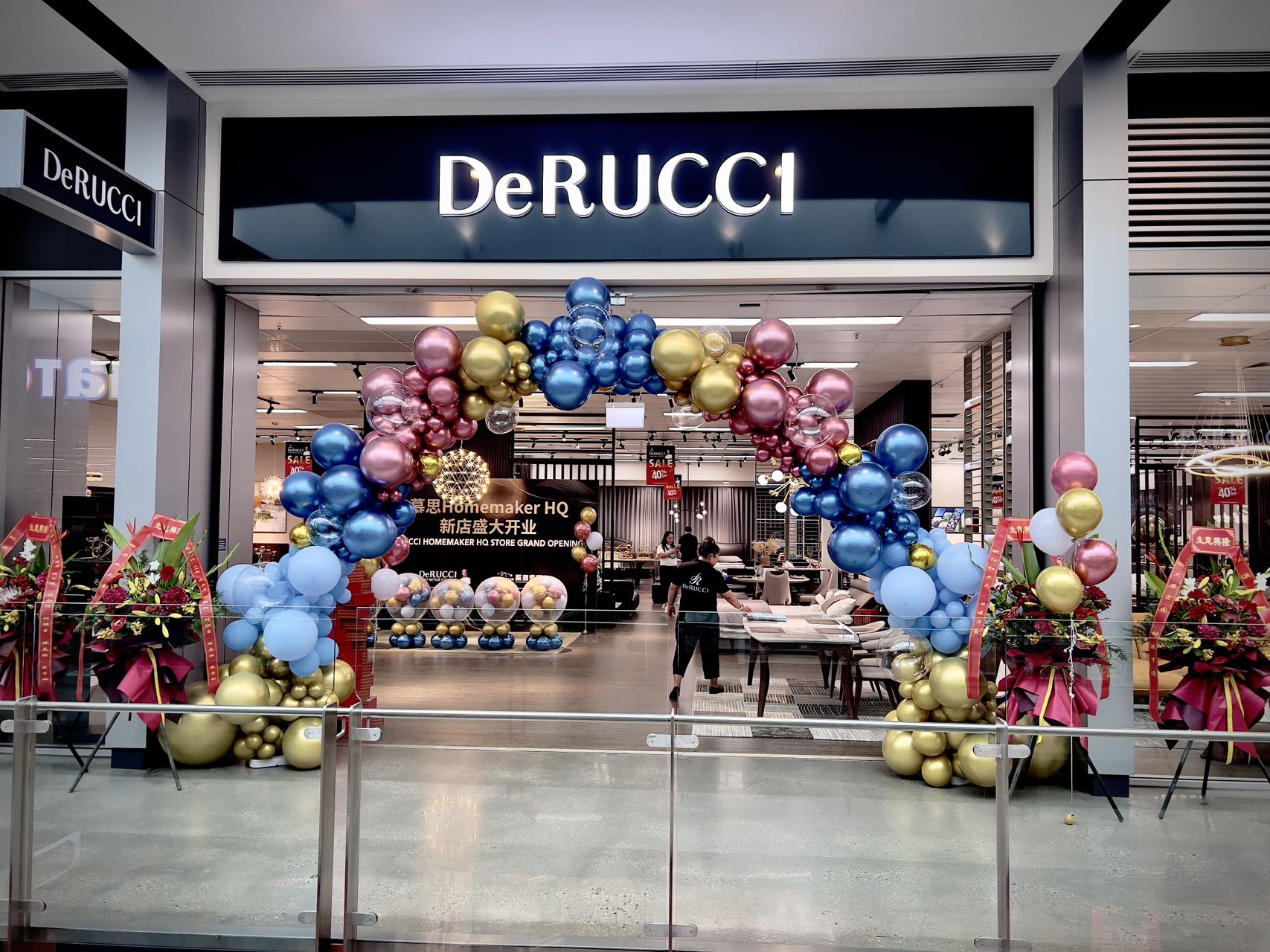 Store grand opening with elegant balloon arch in blue, pink and gold