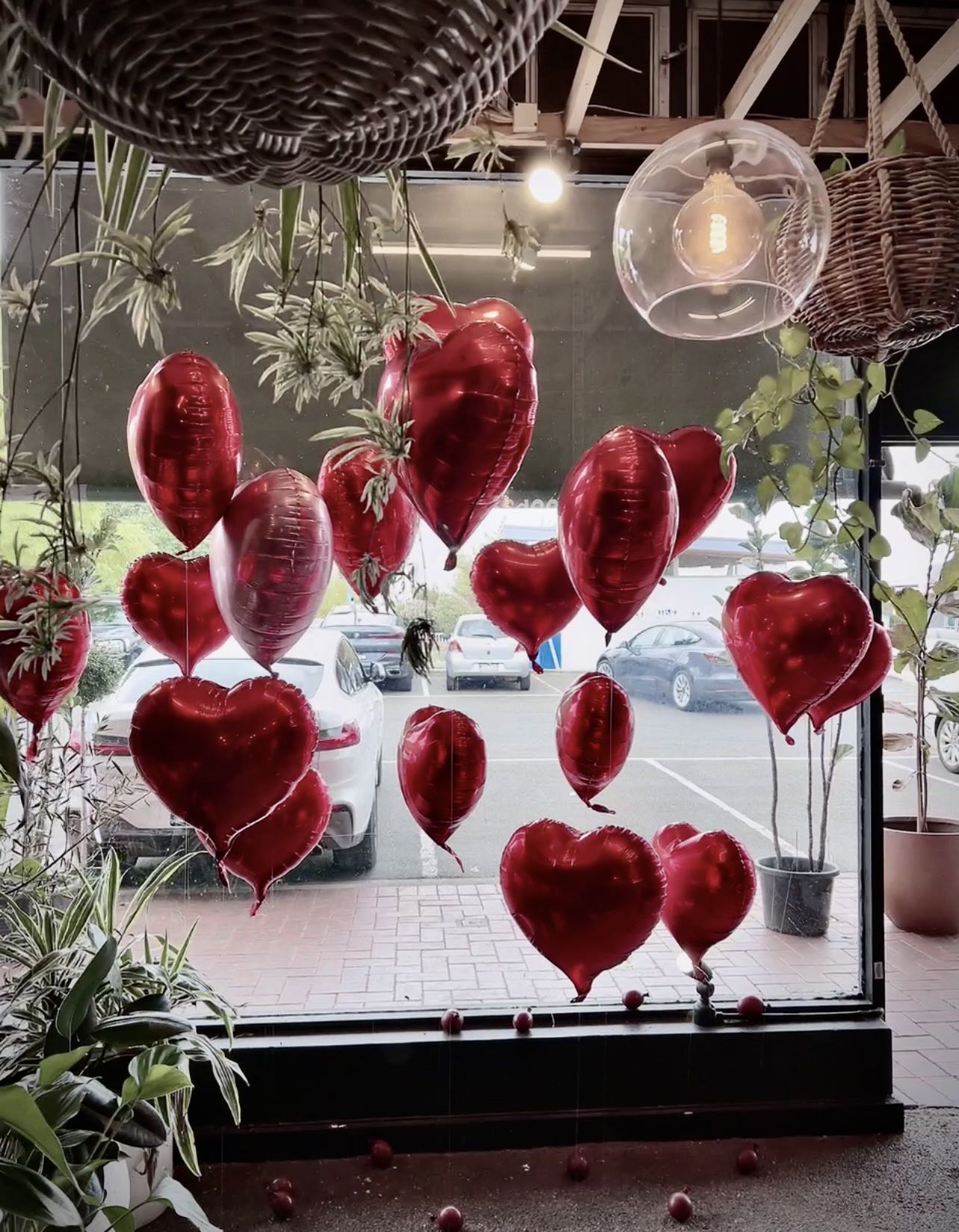 Romantic Valentines Day window display with red and pink heart balloons