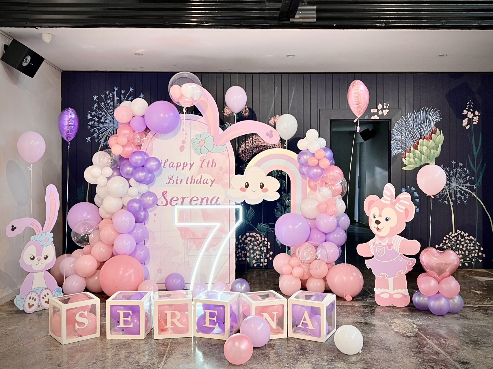 Magical 7th birthday setup with pink and purple balloons and bunny decorations