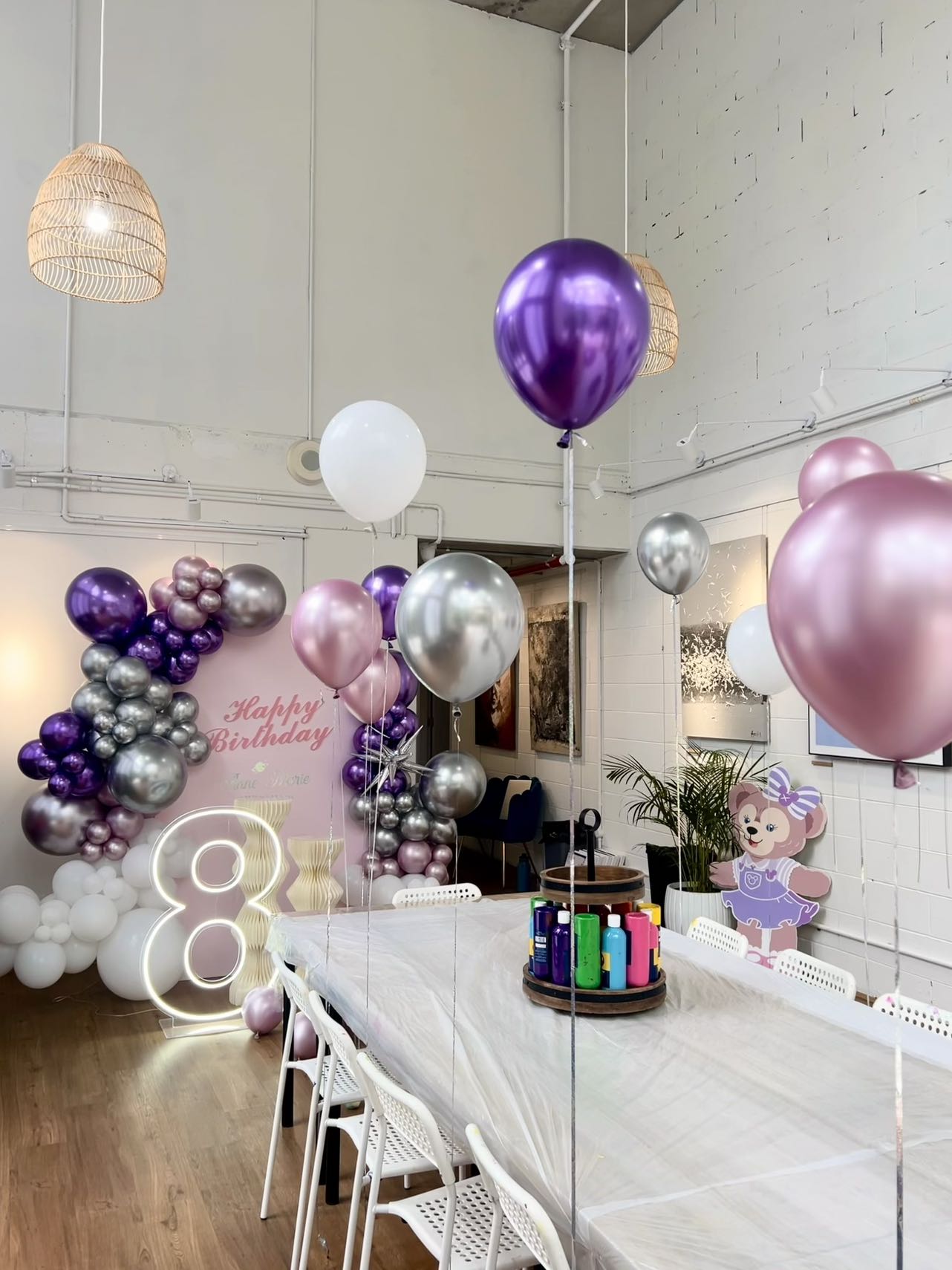 Modern 8th birthday celebration with purple, pink and silver balloon decorations