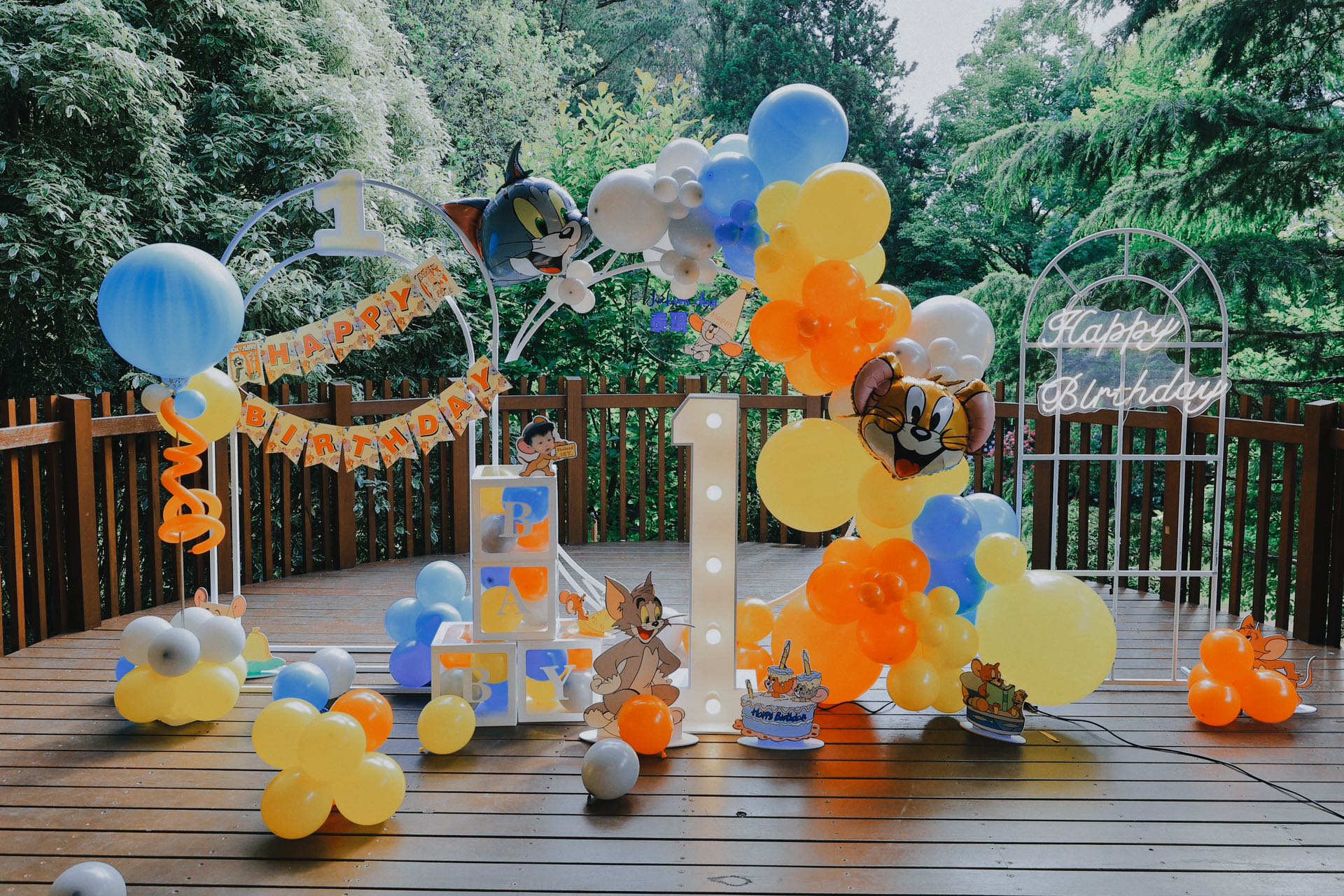 Tom and Jerry themed outdoor party with blue, yellow and orange balloons