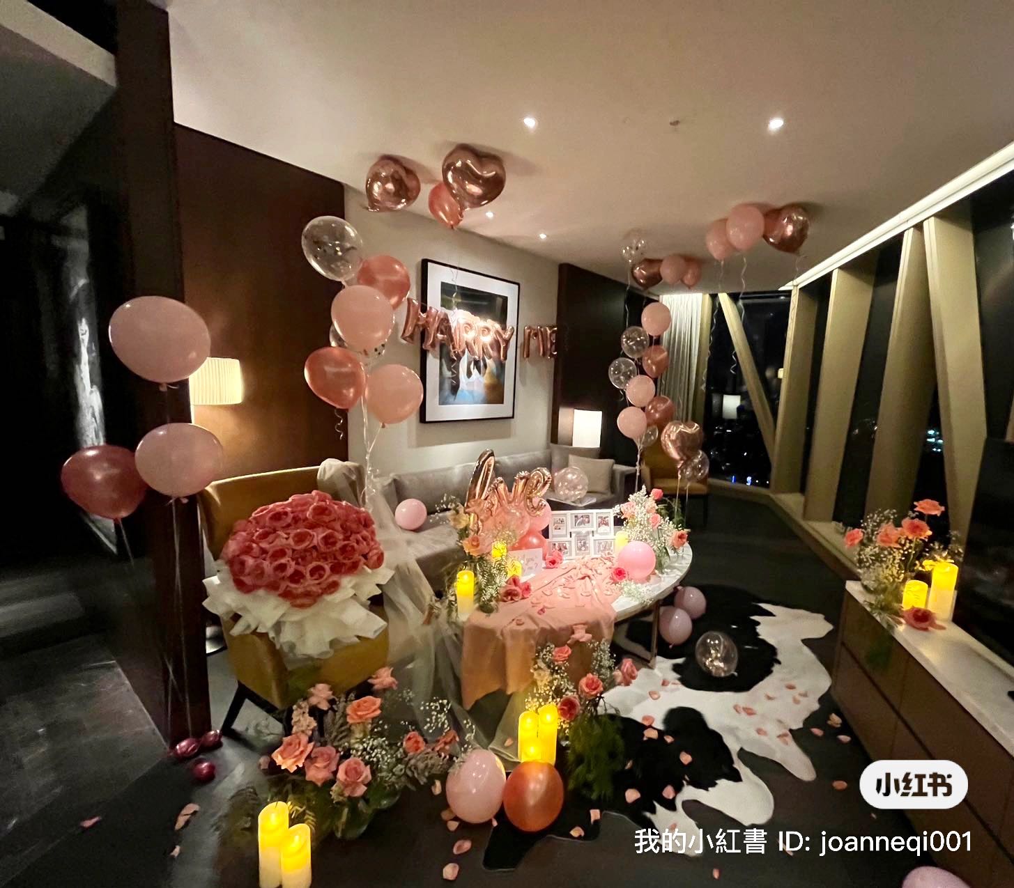 Intimate candlelight proposal setup with rose gold balloons and fresh flowers