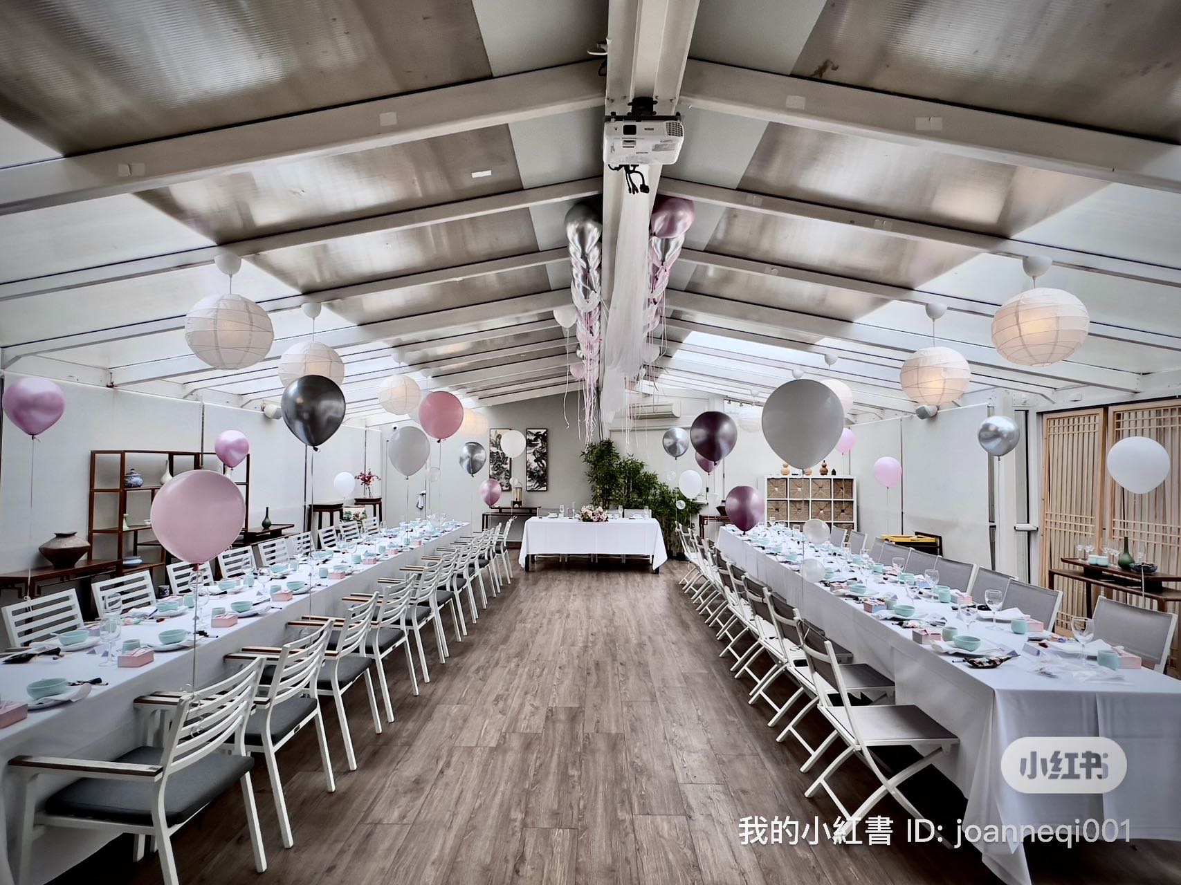 Elegant wedding reception with pink and silver balloons and paper lanterns